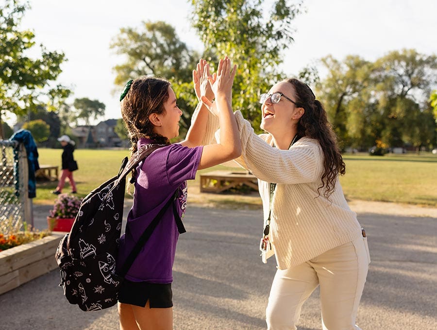 Science inquiry Teacher and student doing a highfive