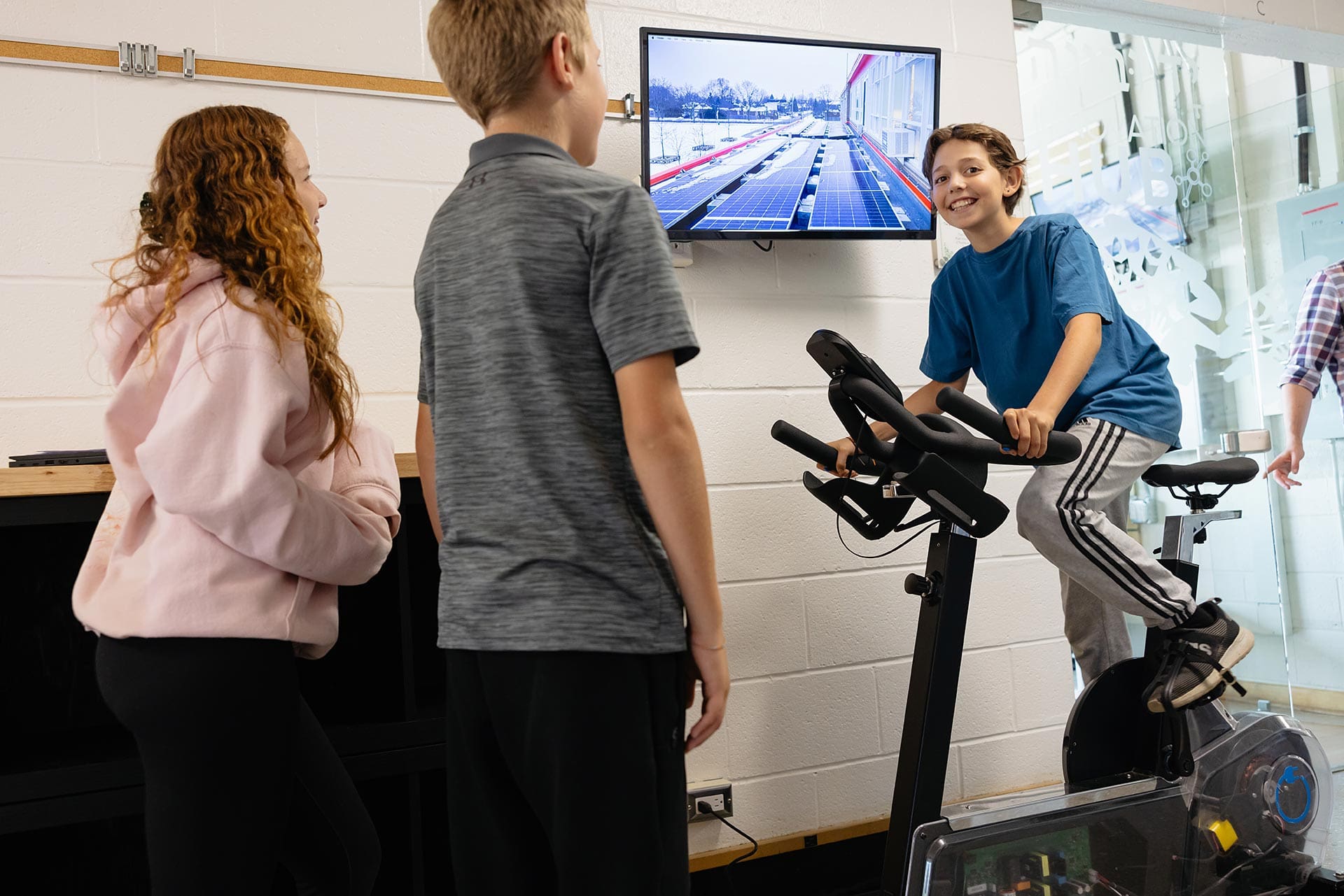 Social-Emotional Learning (SEL) - three students interacting, with one in a staionary bike