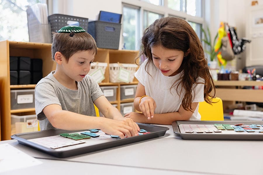 Two young students doing an activity in the classroom